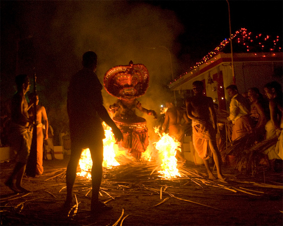 Another fire Theyyam where the performer jumps repeatedly through the bonfire