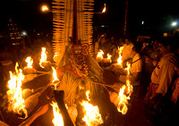 A Fire Theyyam  with 16 fire torch around the waist upon a sheath of  coconut leaves.