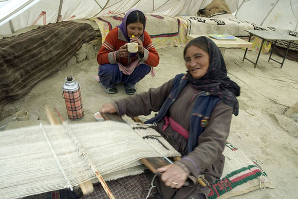 A Changpa woman knitting pashmina with her backstrap loom in her tent