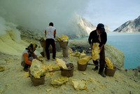 Three miners arrange their loads beside the crater lake before going up the crater path
