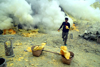 A miner runs with a block of sulphur to fill his basket