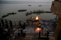 Dusk gathers over the Ganga as funeral pyres laid out on  Manikarnika blaze on under the watchful eyes of the doms, the guardians of the dead.