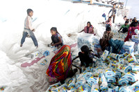 Agariya women and children working in a local salt factory.